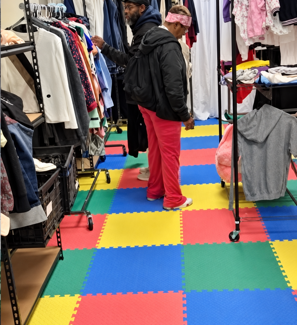 Visitors browsing clothing inside the Changing Lives 365 Fashion Pantry